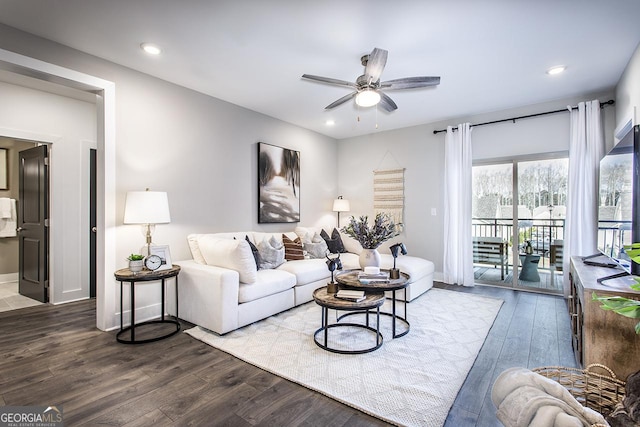 living room featuring ceiling fan and hardwood / wood-style floors