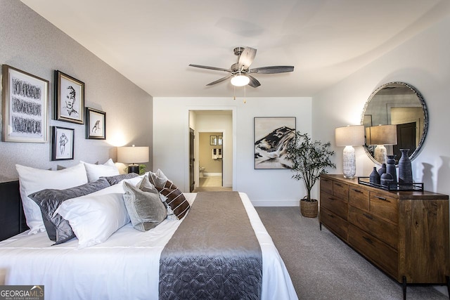 carpeted bedroom featuring ensuite bath and ceiling fan