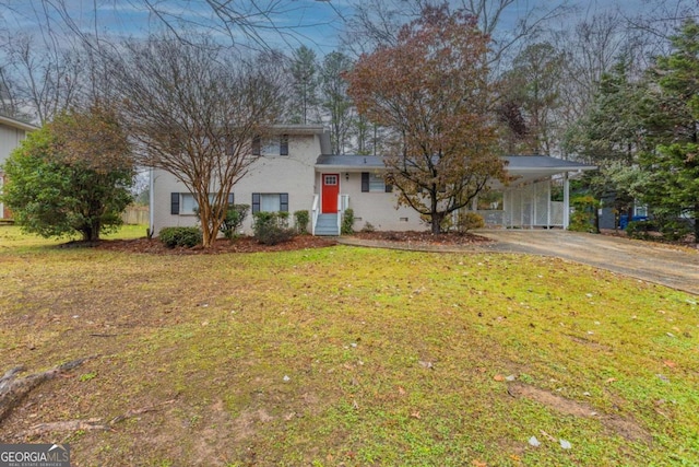 view of front of house with a front yard and a carport