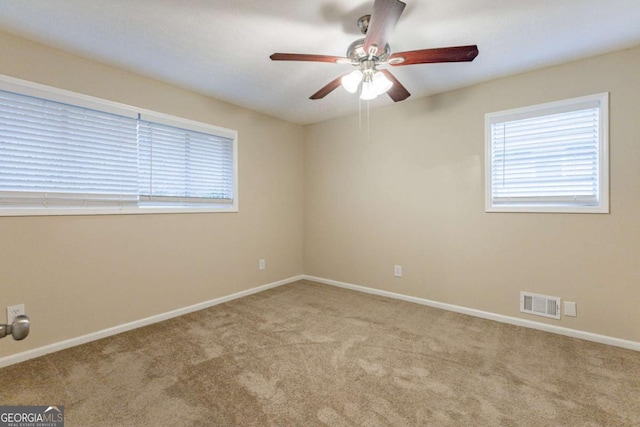 carpeted empty room featuring ceiling fan