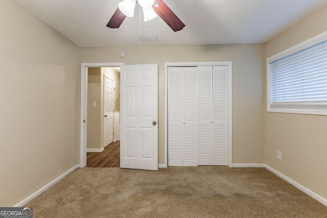 unfurnished bedroom with carpet, a closet, and ceiling fan