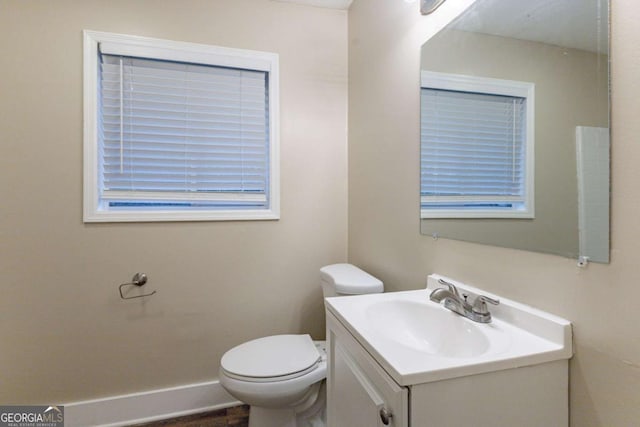 bathroom featuring vanity and toilet