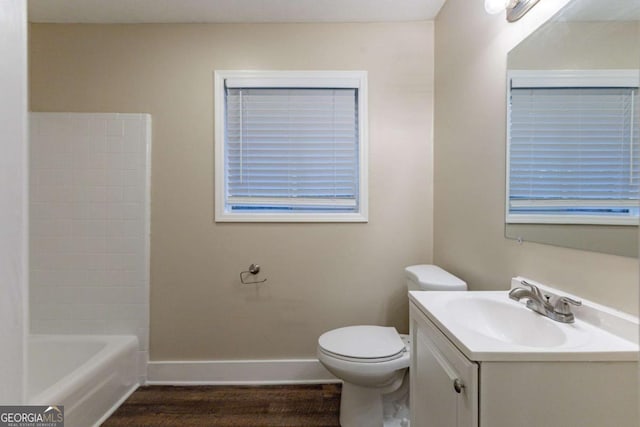 full bathroom featuring vanity, hardwood / wood-style flooring, toilet, and shower / washtub combination