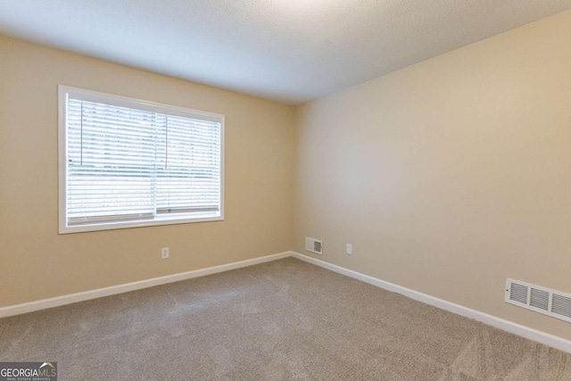 empty room featuring light carpet