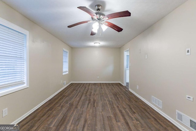 unfurnished room featuring a textured ceiling, dark hardwood / wood-style floors, and ceiling fan