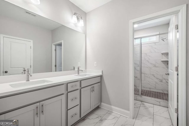 bathroom with a shower with door and vanity