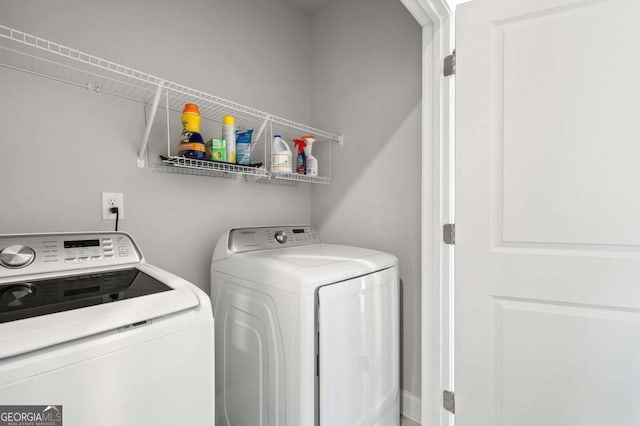 laundry area with washing machine and clothes dryer