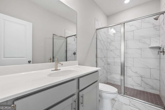 bathroom featuring toilet, vanity, and walk in shower