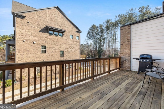 wooden terrace featuring a grill