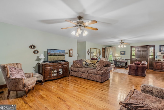 living room with ceiling fan and light wood-type flooring