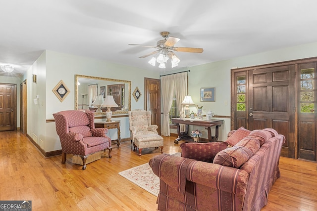 living room featuring light hardwood / wood-style floors and ceiling fan