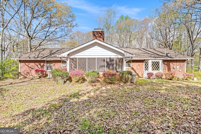 back of property with a sunroom