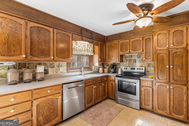 kitchen with backsplash, stainless steel appliances, ceiling fan, and sink