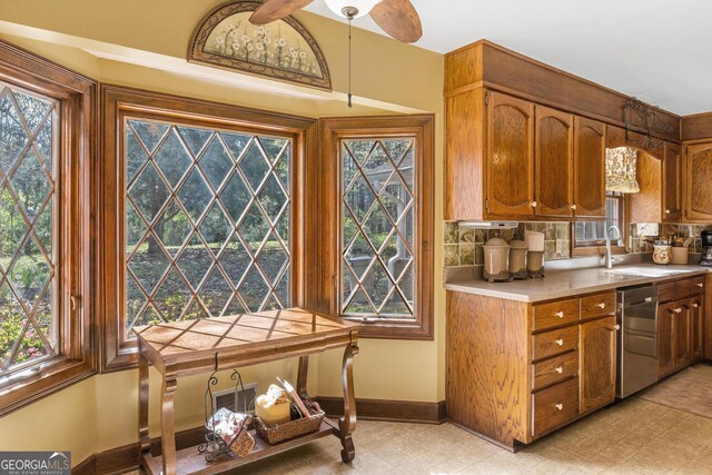 kitchen with a healthy amount of sunlight, hanging light fixtures, and stainless steel dishwasher