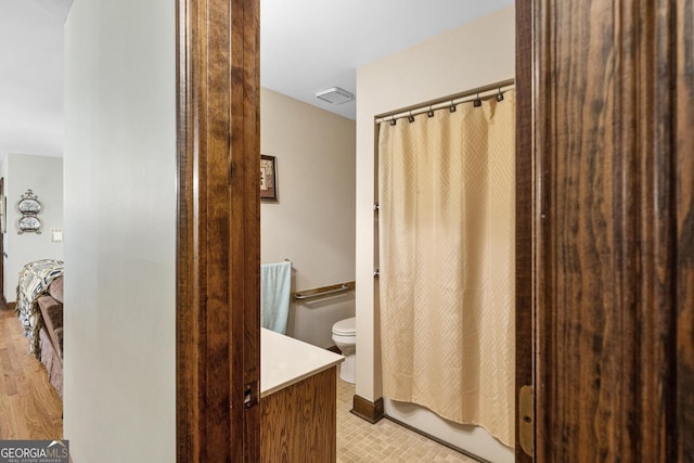 full bathroom with vanity, shower / bath combination with curtain, and toilet