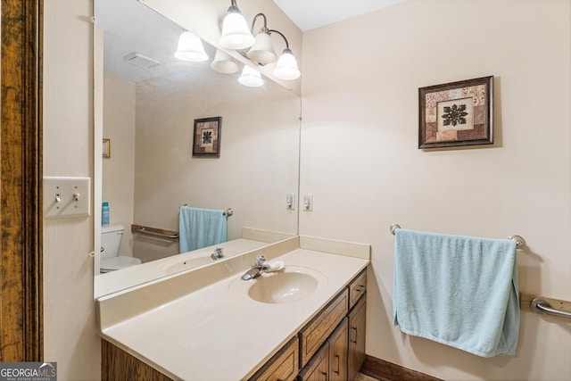 bathroom featuring vanity and toilet