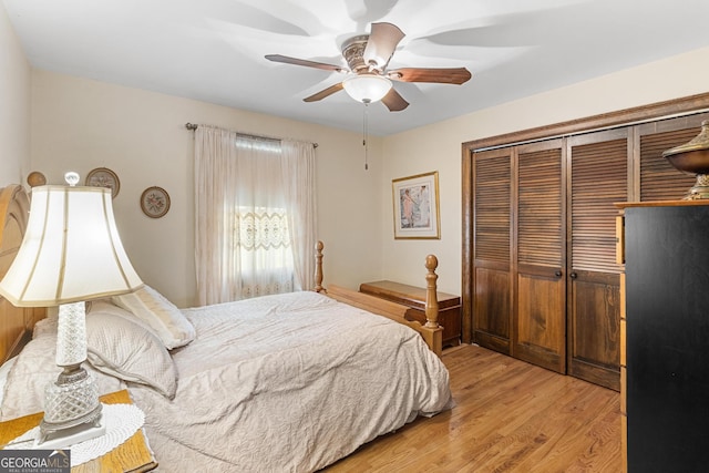 bedroom with ceiling fan, light hardwood / wood-style flooring, and a closet