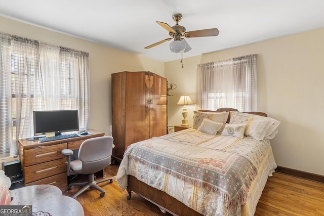 bedroom with ceiling fan and hardwood / wood-style flooring