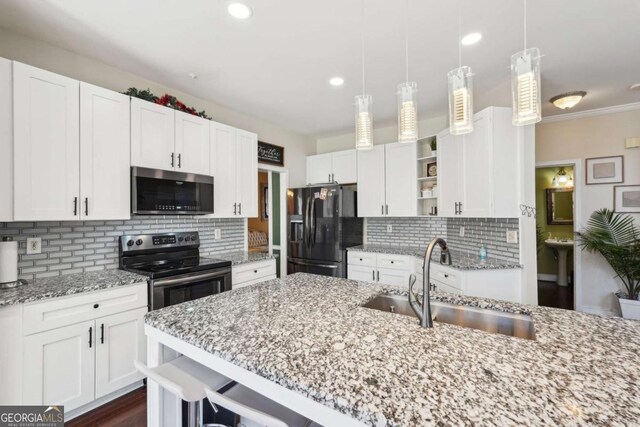 kitchen with decorative backsplash, appliances with stainless steel finishes, white cabinetry, and sink