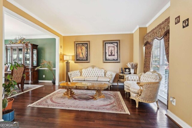 living room featuring dark hardwood / wood-style flooring and crown molding