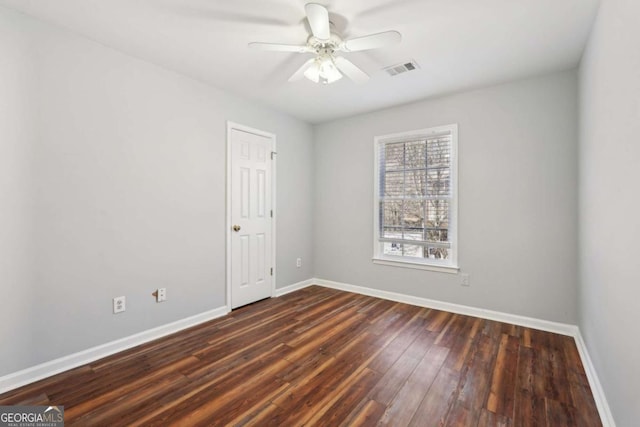 spare room featuring dark hardwood / wood-style flooring and ceiling fan