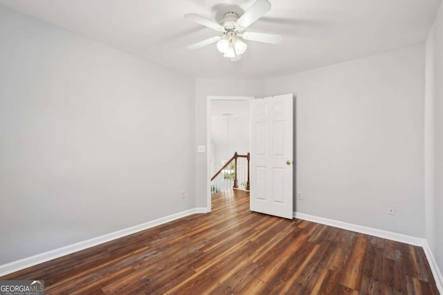 spare room with ceiling fan and dark wood-type flooring