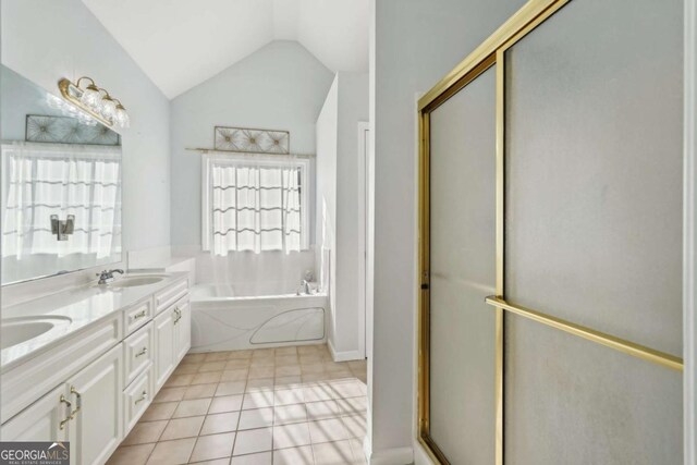 bathroom with tile patterned floors, vanity, vaulted ceiling, and separate shower and tub