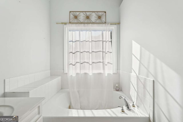 bathroom with a bathtub and vanity