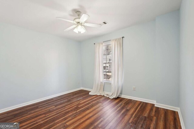 unfurnished room featuring ceiling fan and dark hardwood / wood-style flooring