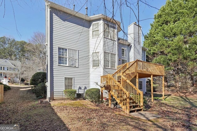 back of house featuring a wooden deck