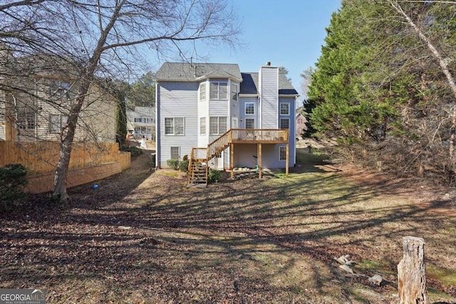 back of house featuring a deck