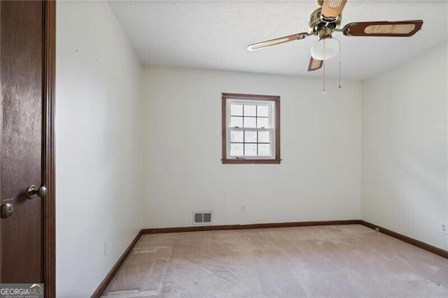 unfurnished room featuring light carpet and ceiling fan