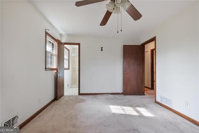 unfurnished bedroom with light colored carpet and ceiling fan