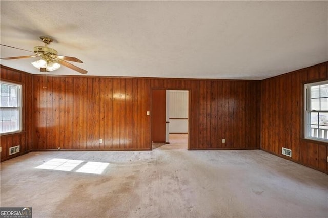 empty room with light carpet and ceiling fan