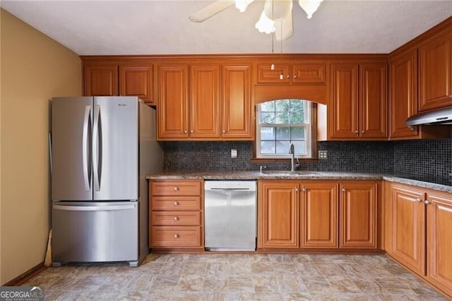 kitchen featuring decorative backsplash, ceiling fan, sink, and stainless steel appliances