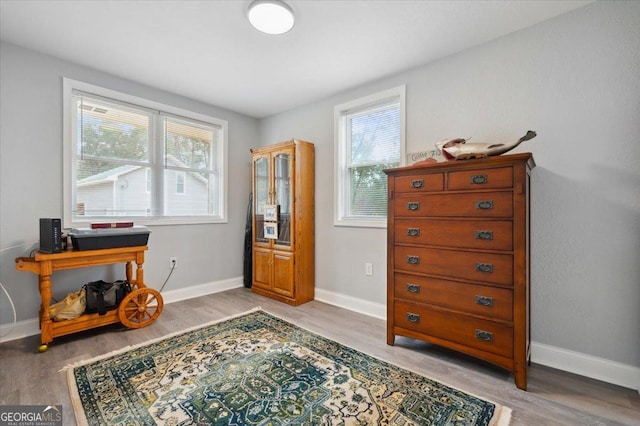 interior space with wood finished floors and baseboards