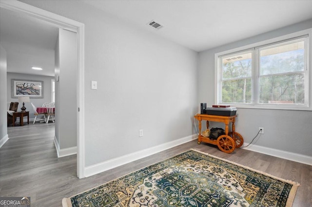 interior space with visible vents, baseboards, and wood finished floors