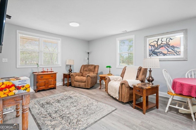 sitting room with light wood-style floors and baseboards