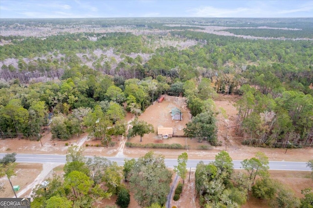 birds eye view of property with a view of trees