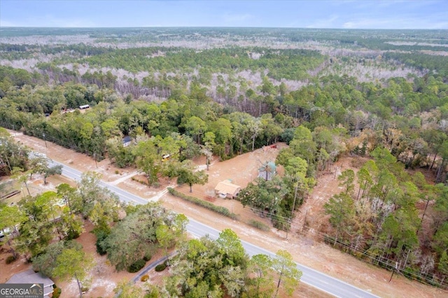 aerial view featuring a wooded view