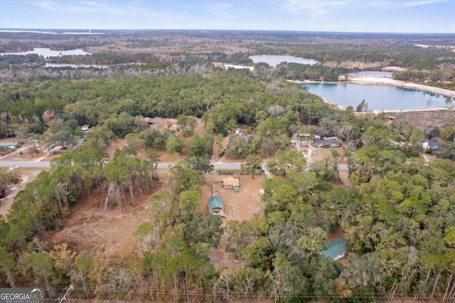 aerial view with a forest view and a water view