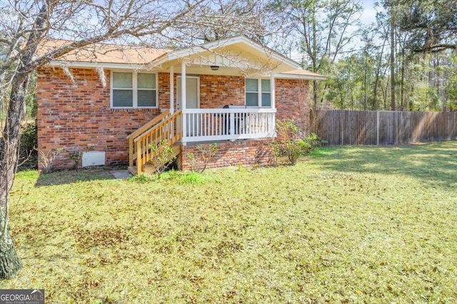 ranch-style house with brick siding, a front yard, and fence