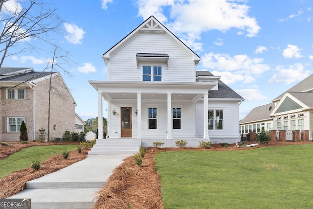 view of front of home with a porch, a shingled roof, and a front lawn