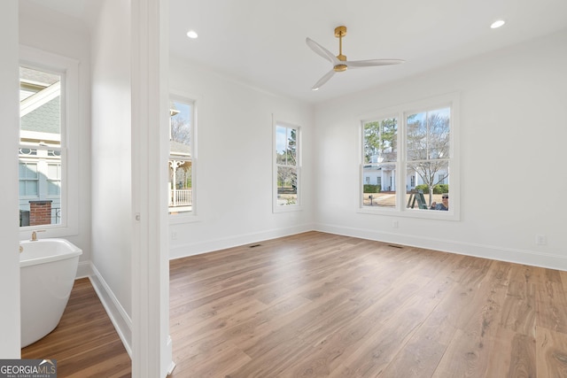 unfurnished room with recessed lighting, visible vents, light wood-style flooring, a ceiling fan, and baseboards