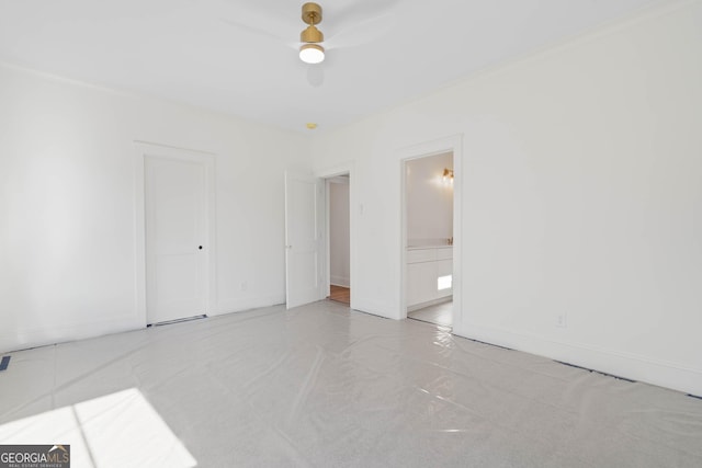 unfurnished bedroom featuring baseboards, a ceiling fan, and ensuite bathroom