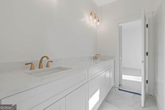 bathroom featuring double vanity, marble finish floor, and a sink
