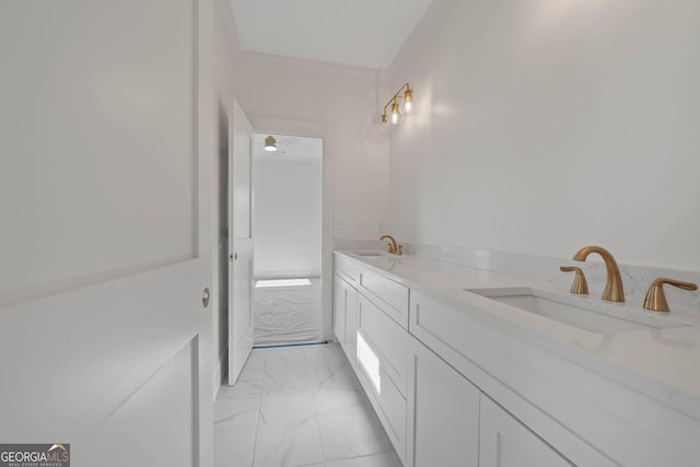 bathroom with marble finish floor, a sink, and double vanity