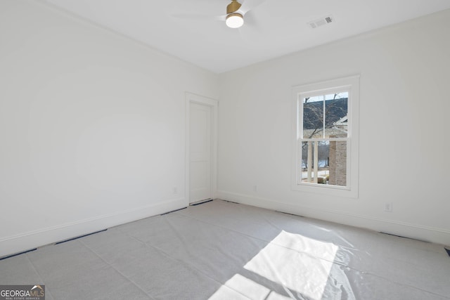 unfurnished room with a ceiling fan, visible vents, and baseboards