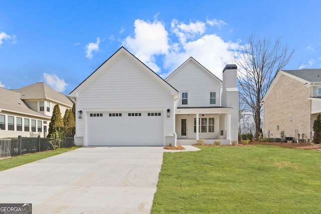 traditional home featuring a garage, fence, concrete driveway, a front lawn, and a chimney