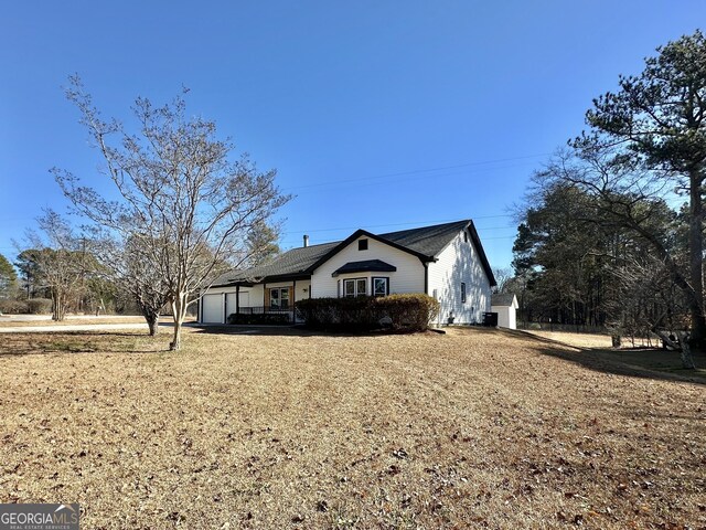 single story home with a porch and a garage